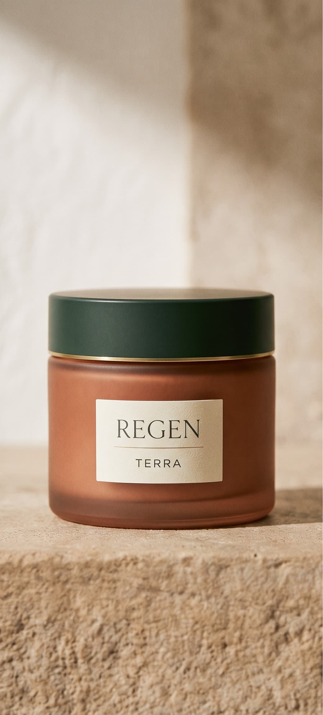Terra clay mask in a terracotta glass jar with a dark green lid, on a warm stone surface